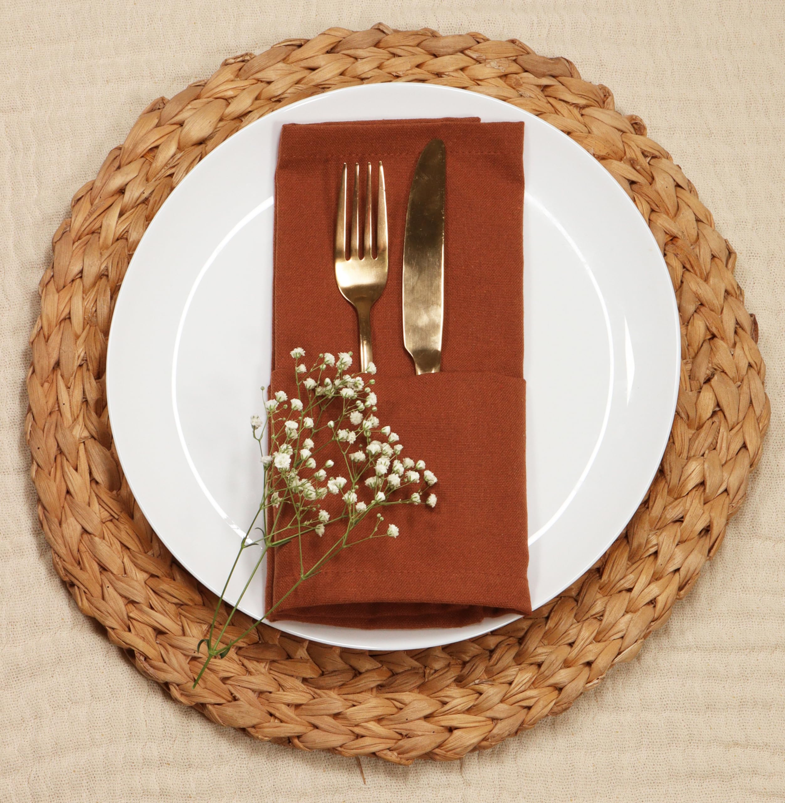 PurpleEssences rust napkins folded on table show neat mitered corners.