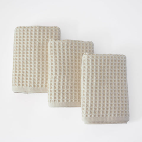 Püskül waffle kitchen towels in natural beige showcasing a soft, absorbent weave.