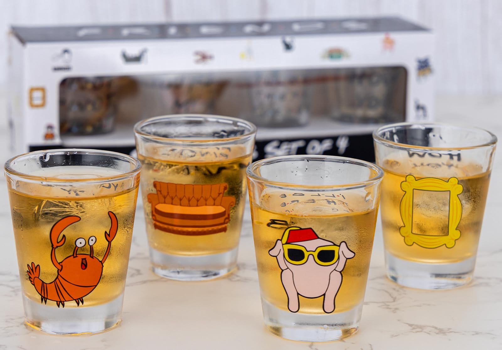 PuGez four-pack Friends shot glasses with iconic quotes for party display.