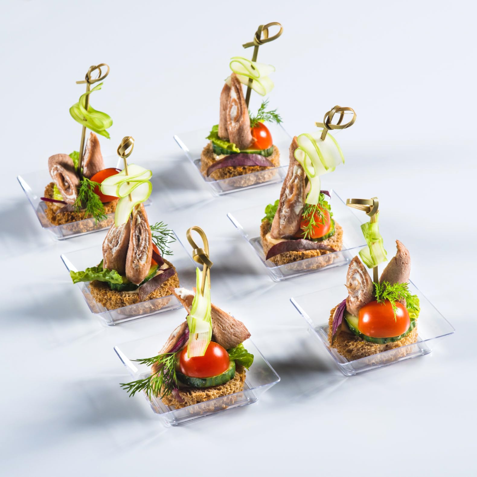 Qeirudu square serving trays for hors-doeuvres at receptions.
