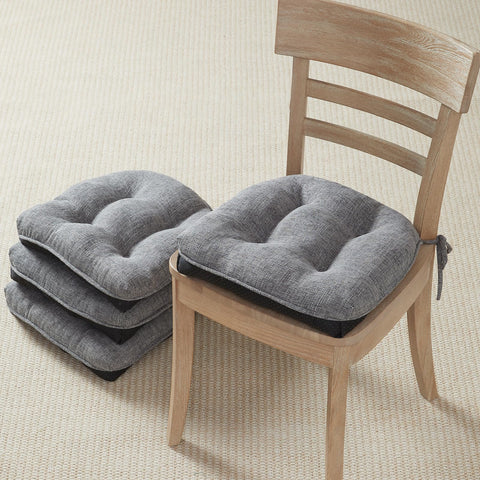 Quilmfoam dining chair cushions in assembly setup for enhanced comfort.