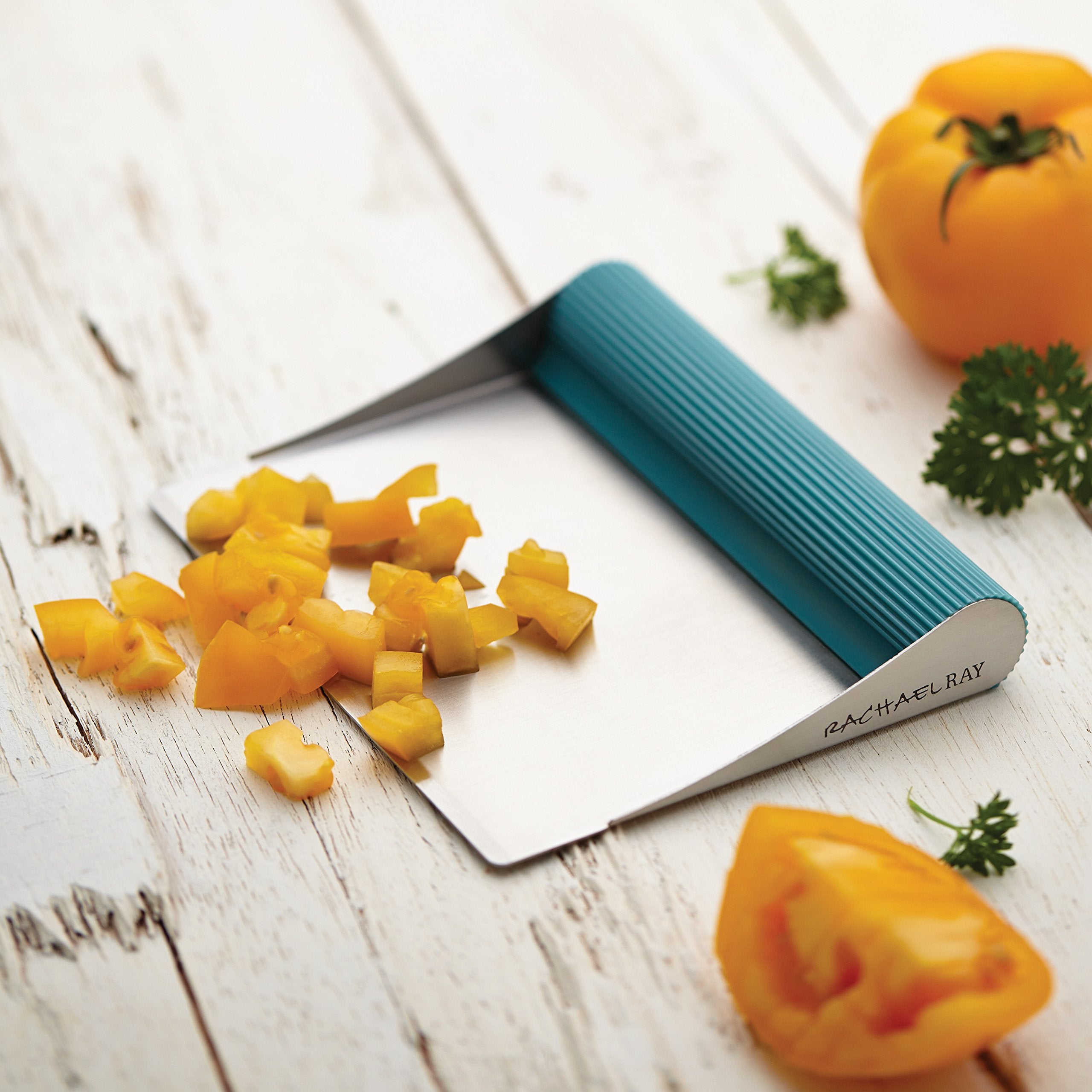 Rachael Ray Cucina bench scrape used to scrape crumbs and residue from the board