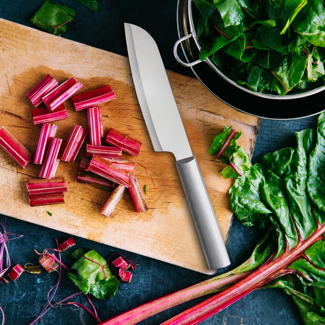 Herbs and vegetables being chopped with even, precise dices