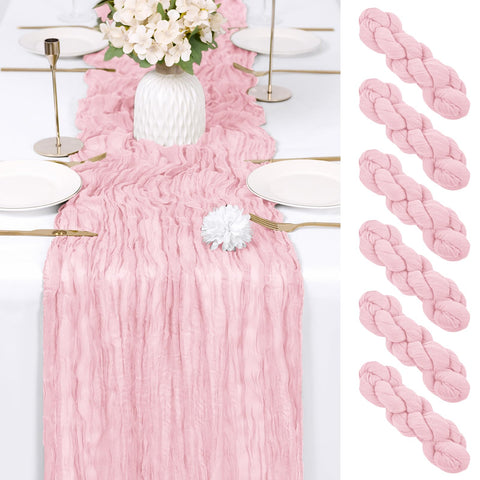 RealBox light pink cheesecloth table runner draped on a dining table for weddings and parties.