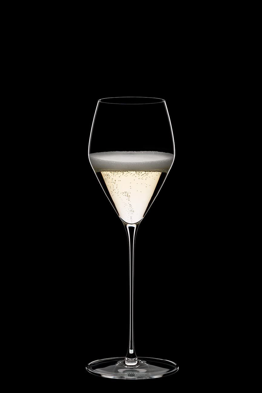 Riedel Veloce champagne glass in use at celebration table shows elegant presence.