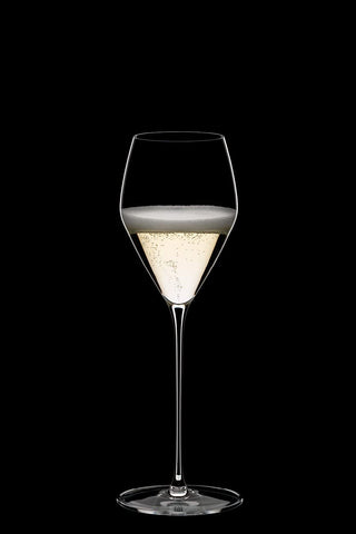 Riedel Veloce champagne glass in use at celebration table shows elegant presence.