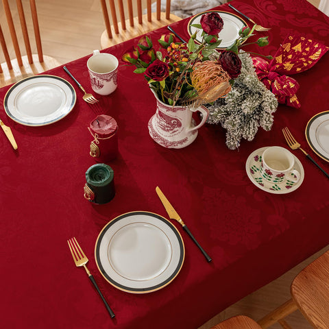 Romanstile tablecloth on holiday table showcasing red flower motif for Xmas decor.