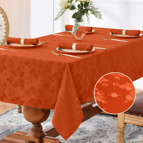 Romanstile jacquard rectangle tablecloth burnt orange on table with elegant floral pattern.