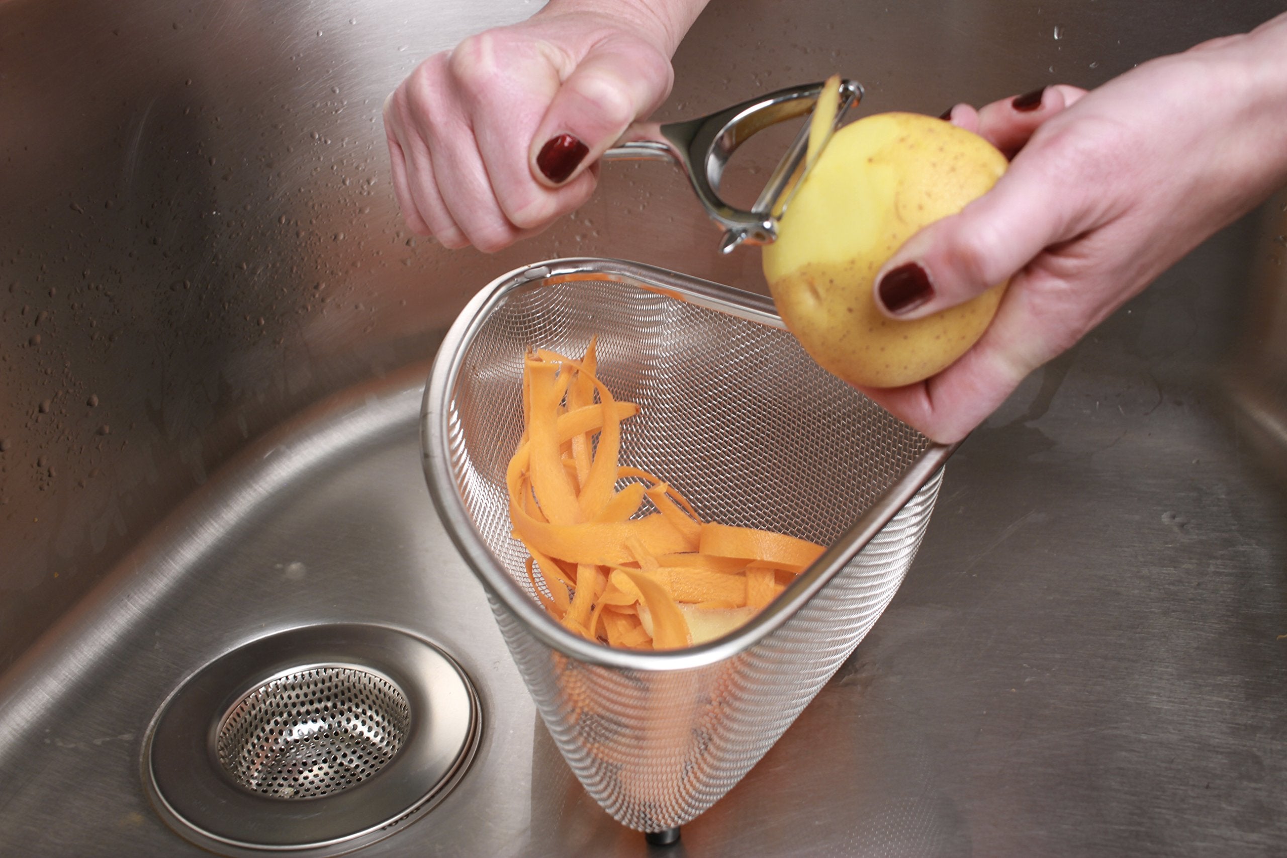 RSVP Endurance small corner basket fits in the sink for compact organization