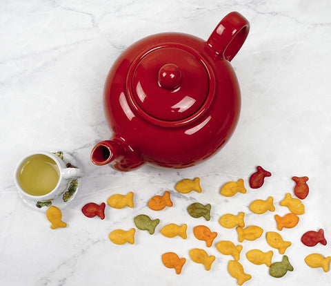 Shiny red RSVP teapot glaze enhances kitchen table presentation.