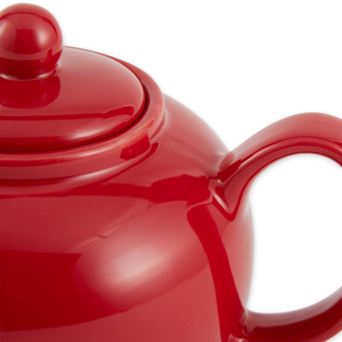 Close-up of RSVP red teapot spout with large drain holes for smooth pouring.