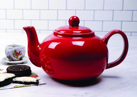 RSVP red teapot on a table, ideal for brunch or tea rituals.