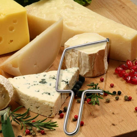 S Aeon Design slicer used with cheese, butter, and fruit.