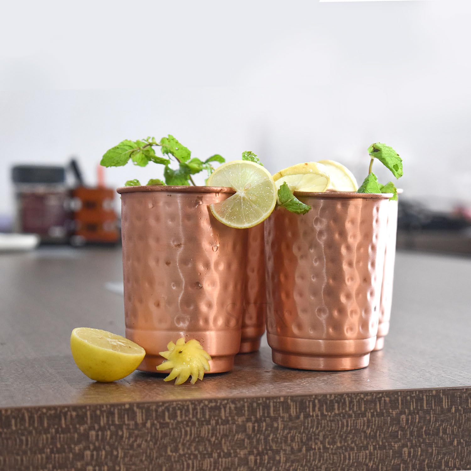 SAJTOX hammered copper tumbler in use with herbal tea and detox water.