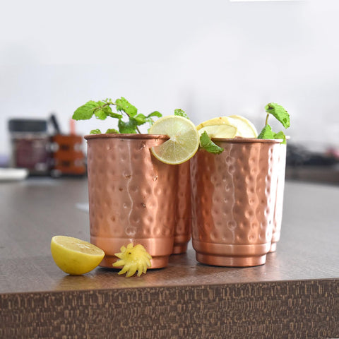 SAJTOX hammered copper tumbler in use with herbal tea and detox water.
