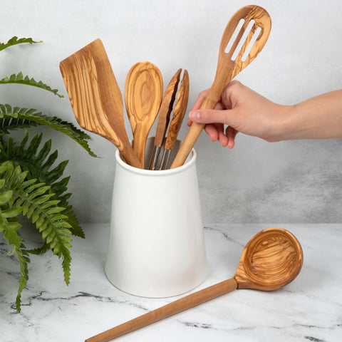 Salt & York olivewood slotted spoon draining excess liquid during sauté.