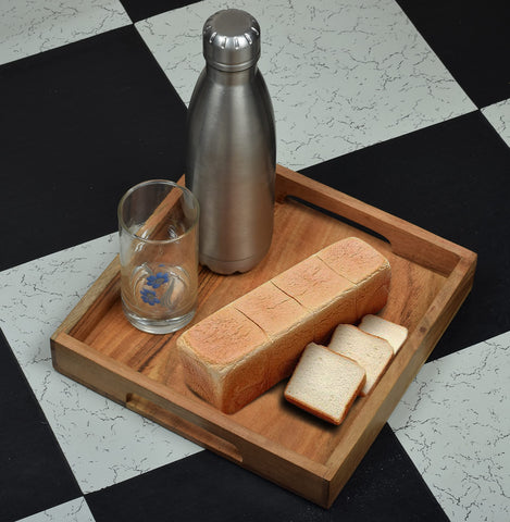 Samhita acacia tray in antique-style finish enhances decor.