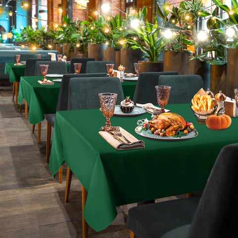 Sancua hunter green tablecloth on a buffet setup for easy cleanup.