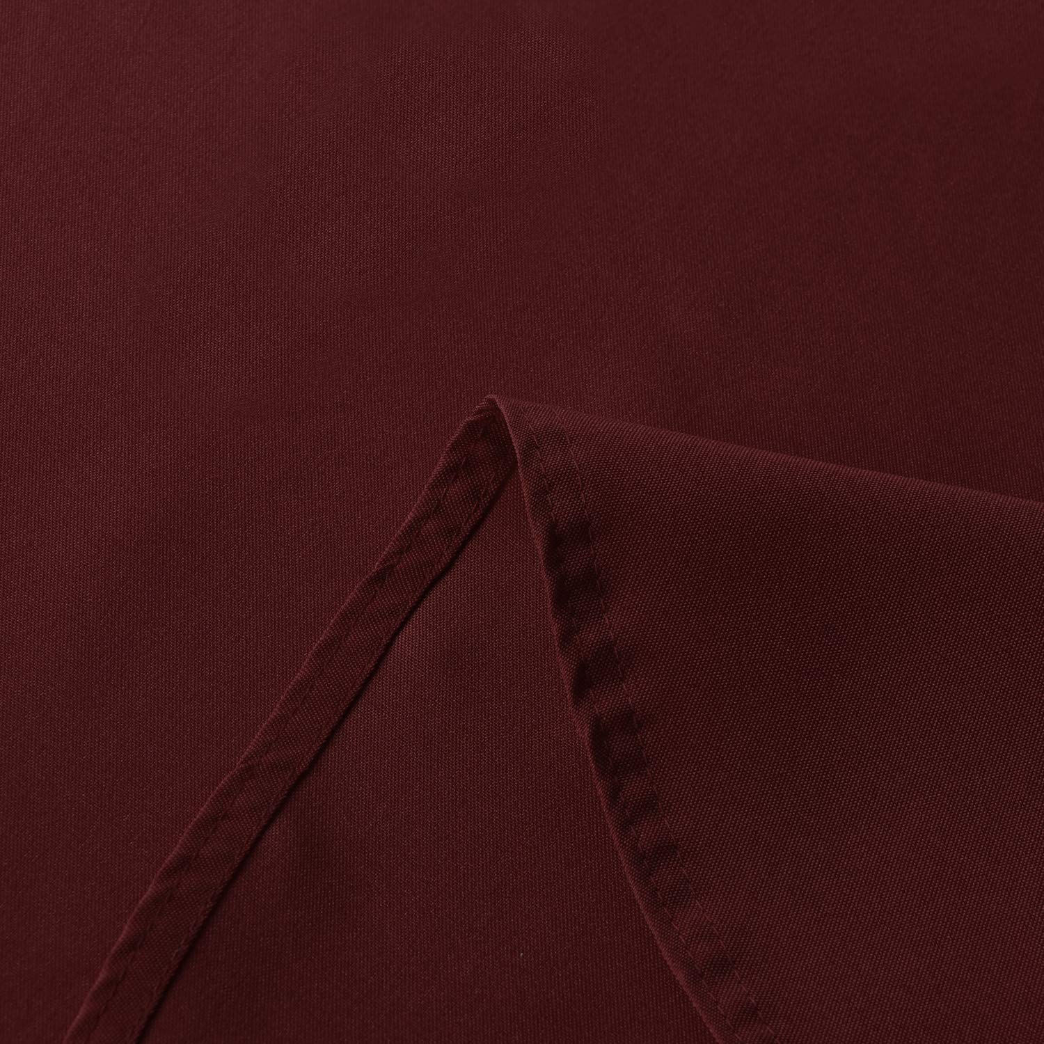 Sancua 90-inch burgundy tablecloth outdoors during party setup for weather-ready decor.