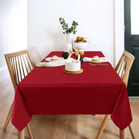 Sancua table setting in a dining room with red cover.