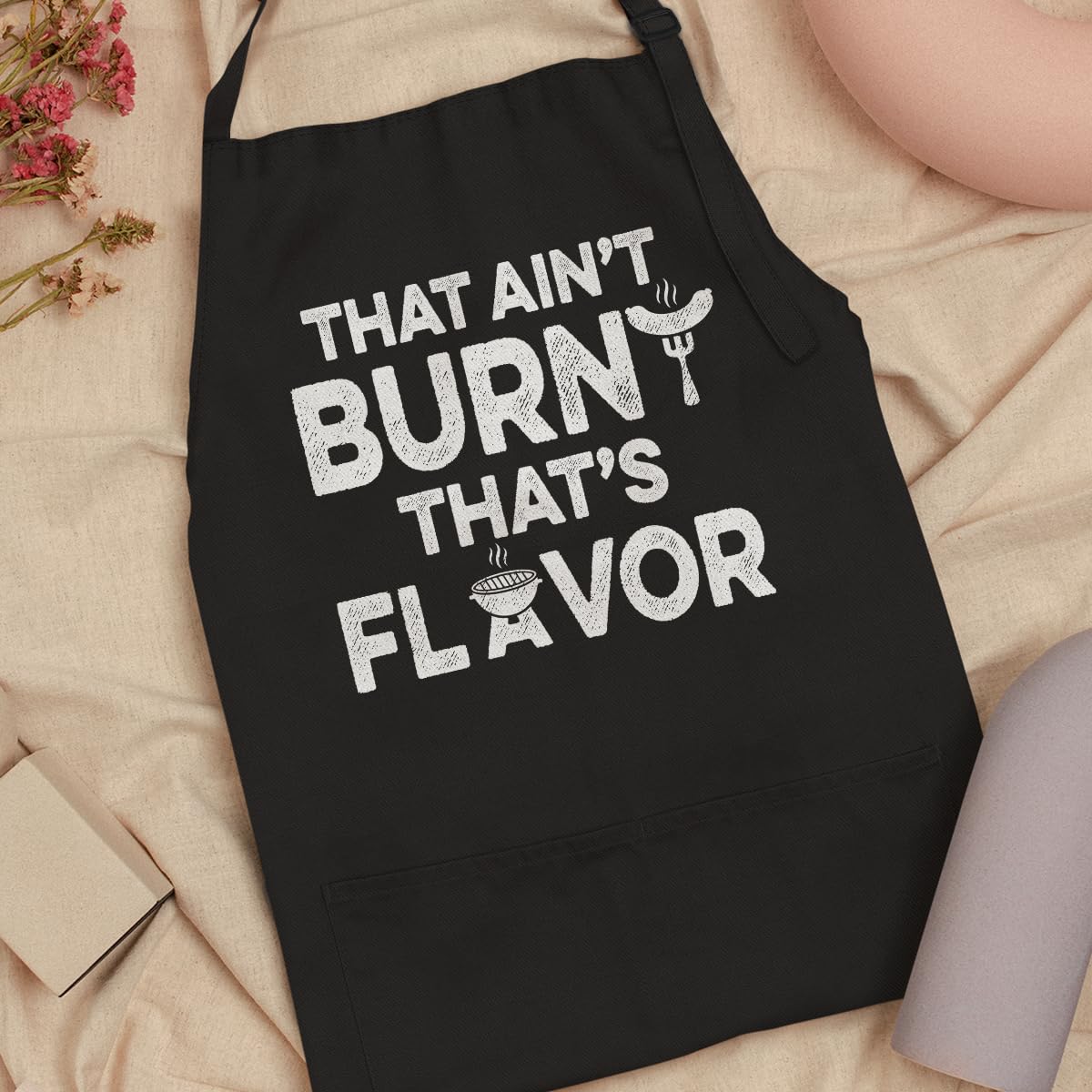 SANDJEST apron in use in a kitchen scene during cooking.