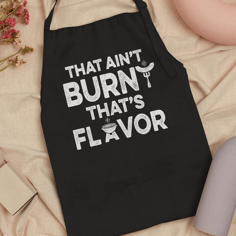 SANDJEST apron in use in a kitchen scene during cooking.