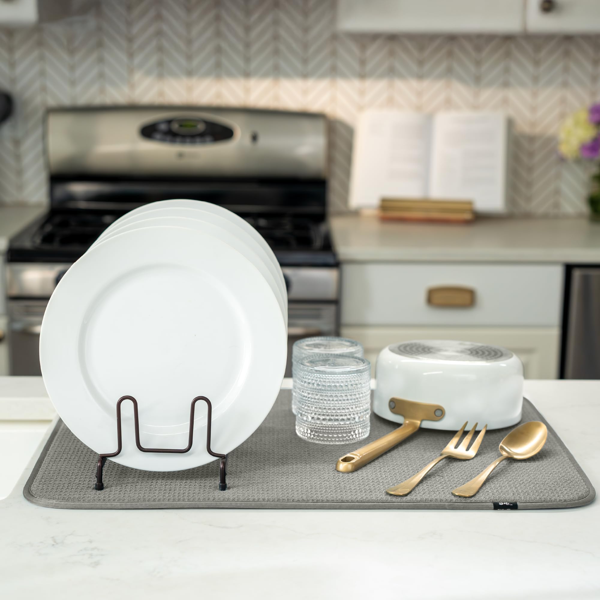 S&T INC. Drip-catching mat under a dish rack helps manage sink drips.
