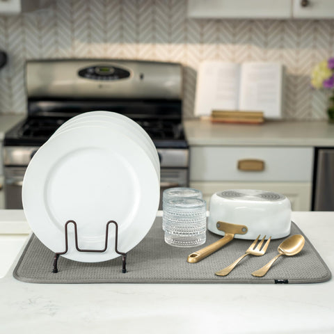 S&T INC. Drip-catching mat under a dish rack helps manage sink drips.