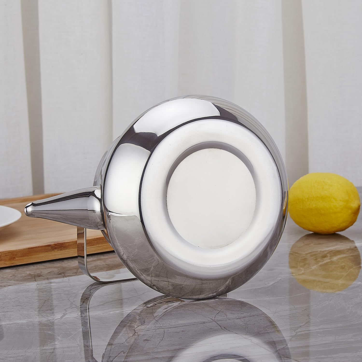 SANQIAHOME teapot in warm, minimalist kitchen adds subtle elegance.
