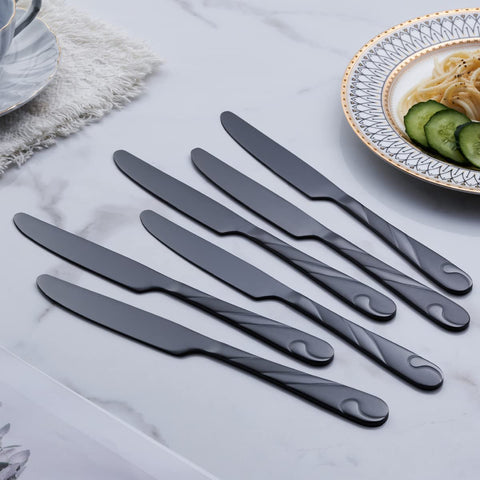 Formal dinner table setting featuring Seeshine black silverware