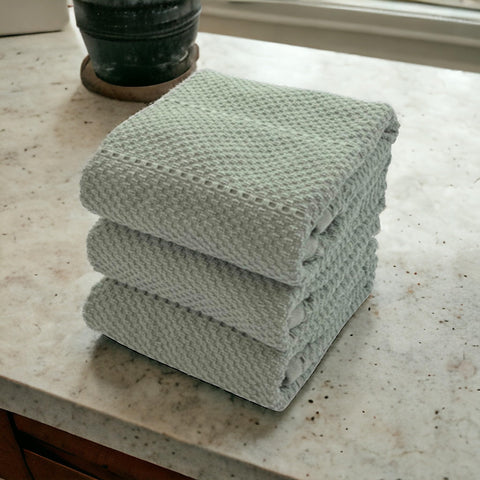 Serafina Home sage green towels with loop enable easy hanging storage.