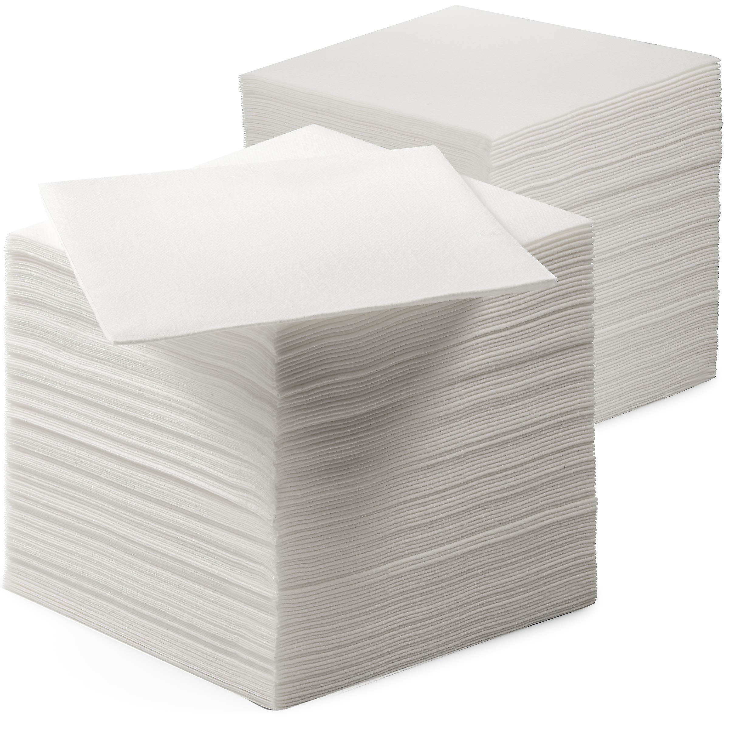 Servietto linen-feel beverage napkins folded on a formal table for clean spills.