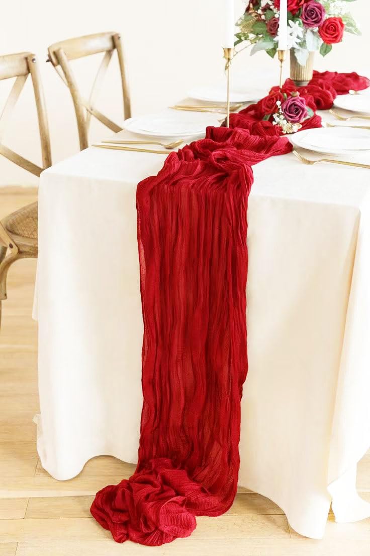 Seveups red table runner complements candles and linens for versatile event decor.