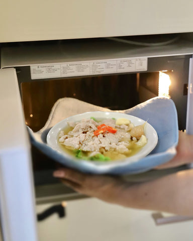 Sheff hot and cold bowl huggers in grey in use on a serving surface