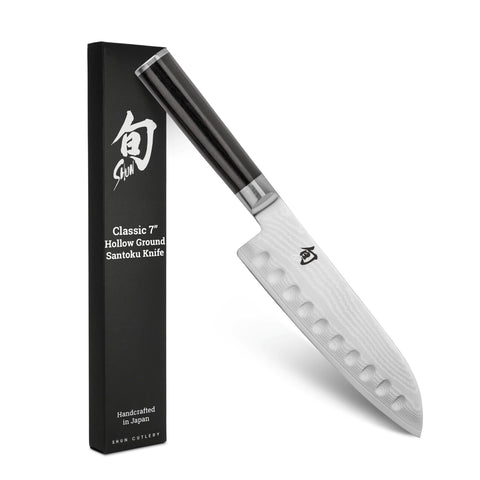 Shun Classic 7-inch hollow-ground santoku blade for smooth vegetable and protein slicing.