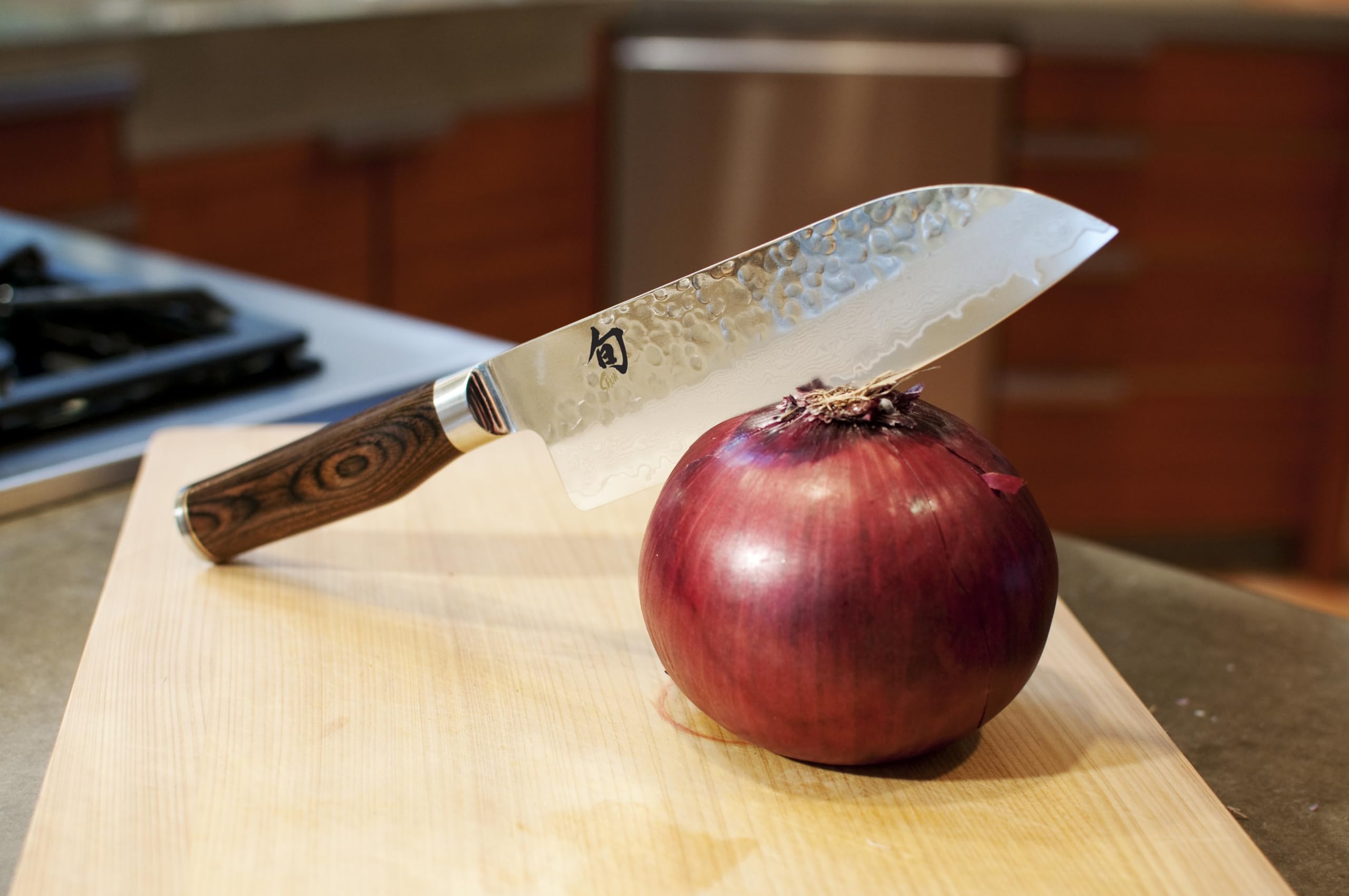 Shun Premier blade reveals VG-MAX Damascus core and layered finish.
