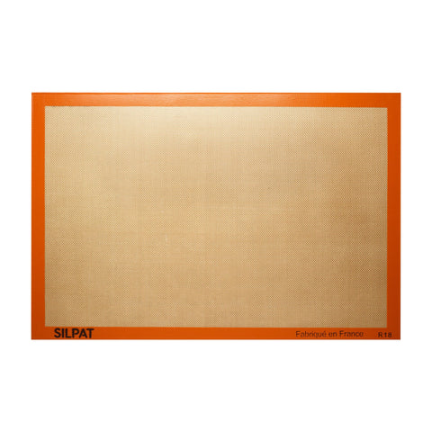 Silpat original non-stick baking mat fullsize on a sheet pan for easy release