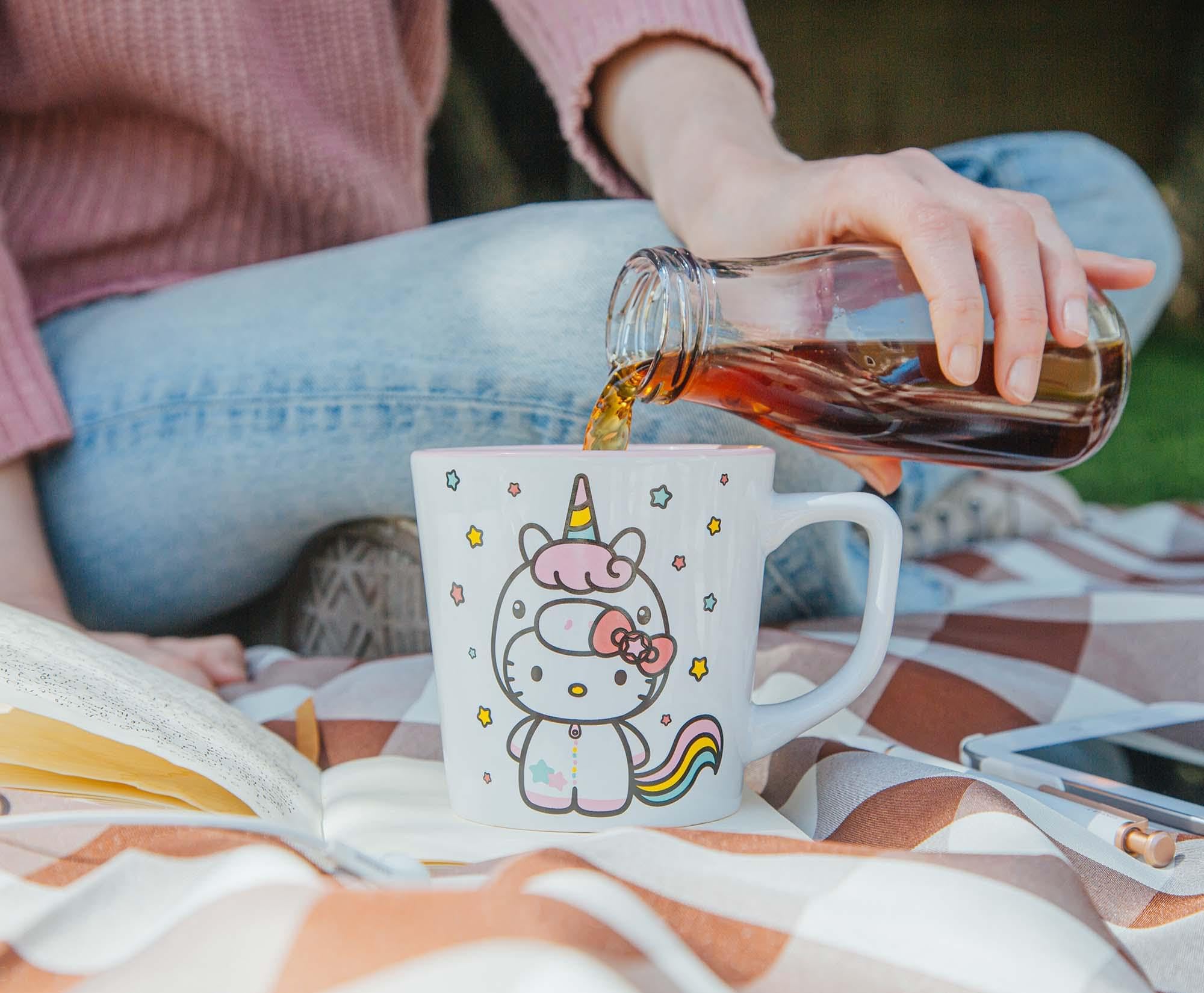 Silver Buffalo Hello Kitty Unicorn mug stacked with other Sanrio collectibles.