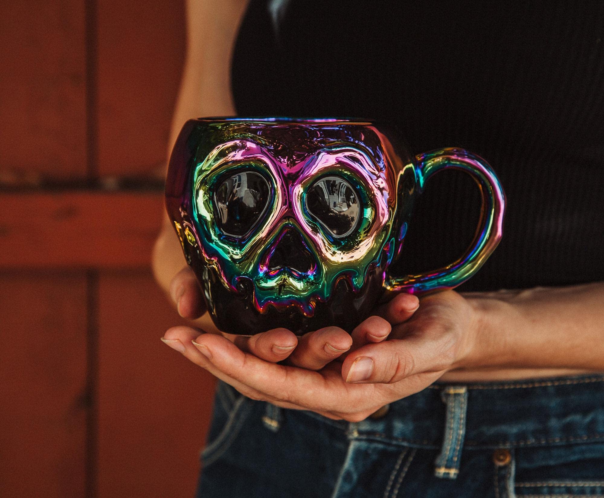 Silver Buffalo iridescent finish poison apple mug catching light for magical moments.