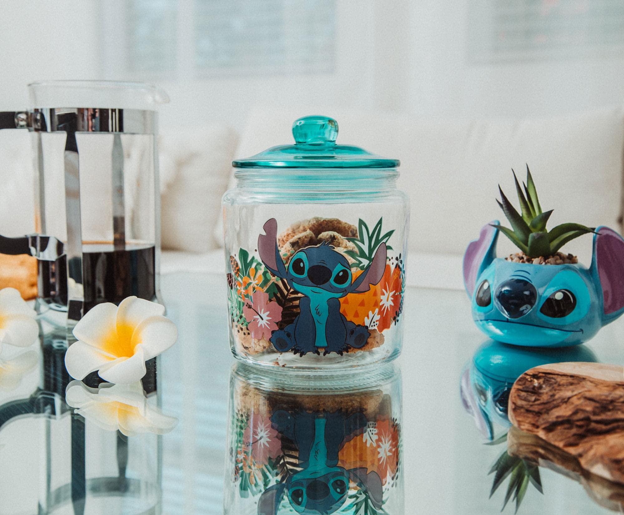 Tropical pineapples and palm leaves accent the jar's design for a vibrant kitchen look.