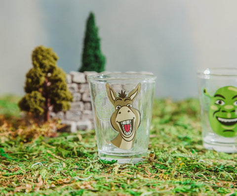 Colorful Shrek graphics on Silver Buffalo shot glass, ideal for party toasts.
