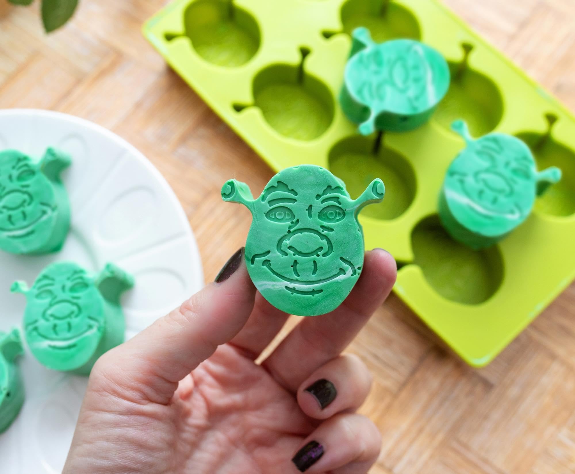 Shrek ice tray in use adding playful character to beverages.