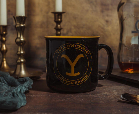 Silver Buffalo camper mug holding steaming coffee in outdoor setting