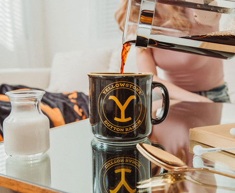 Silver Buffalo Yellowstone mug on rustic surface with Dutton Ranch logo