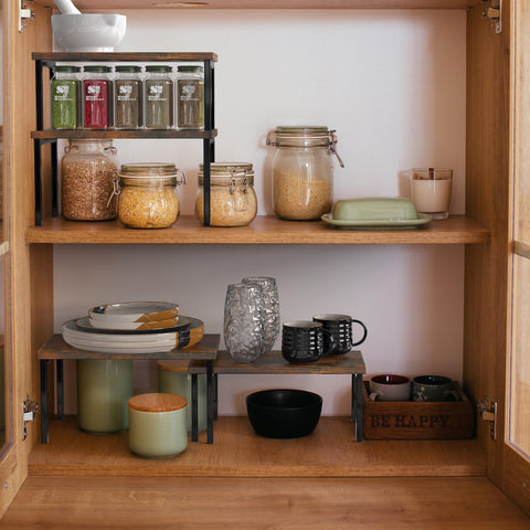 Simple Houseware stackable shelves create more cabinet space for plates and cups.
