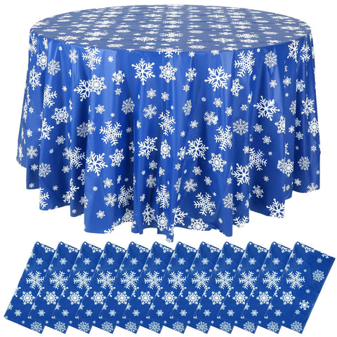 Sliner blue snowflake round tablecloth covers an 84-inch table for festive winter gatherings.
