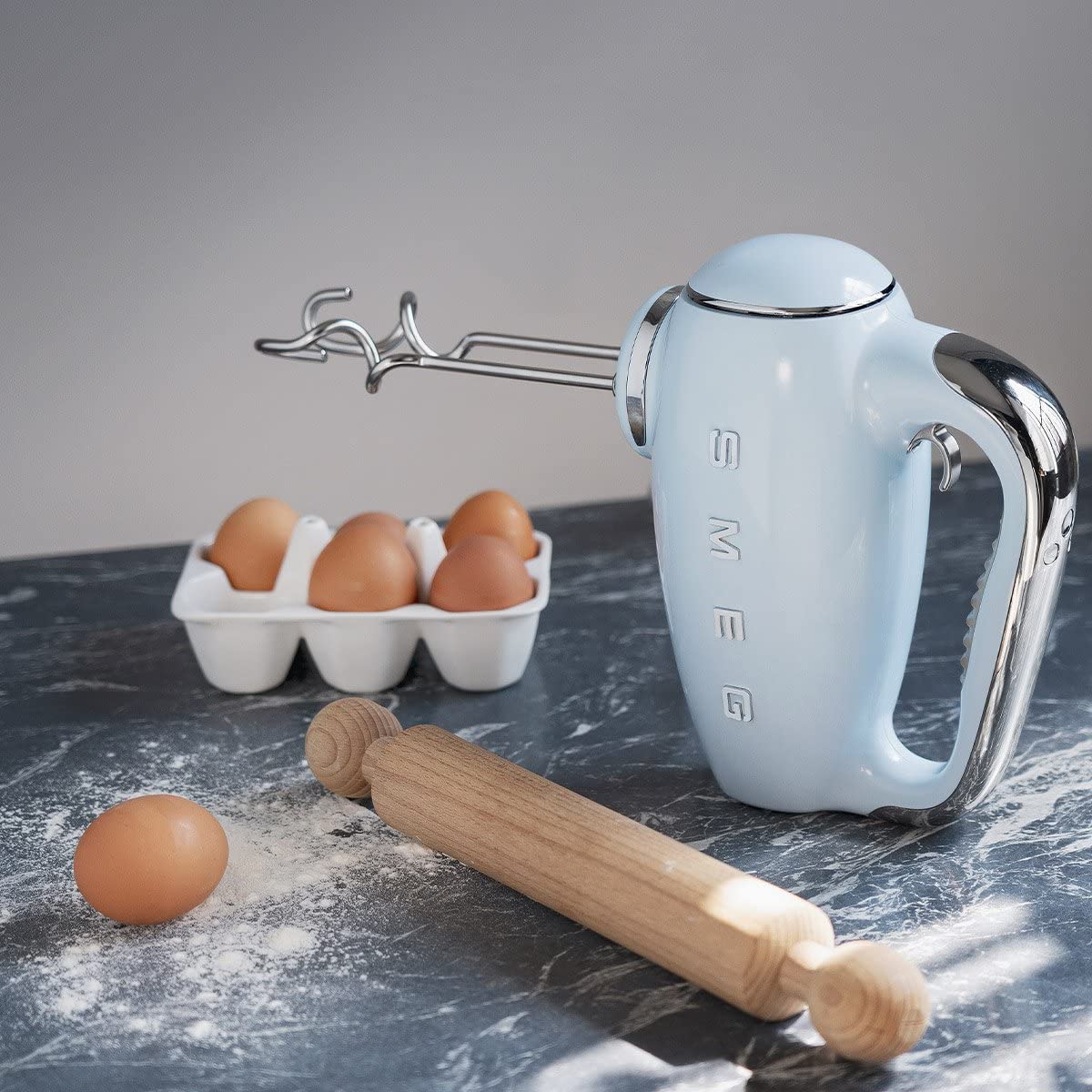 Smeg pastel blue hand mixer with beaters and attachments for versatile baking