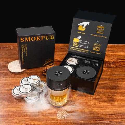Smokpub smoker resting on glass to infuse a smoky cocktail.