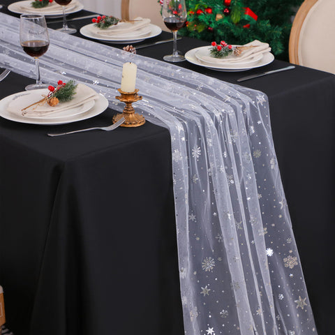 Snowkingdom silver snowflake table runner on full table for festive dining.