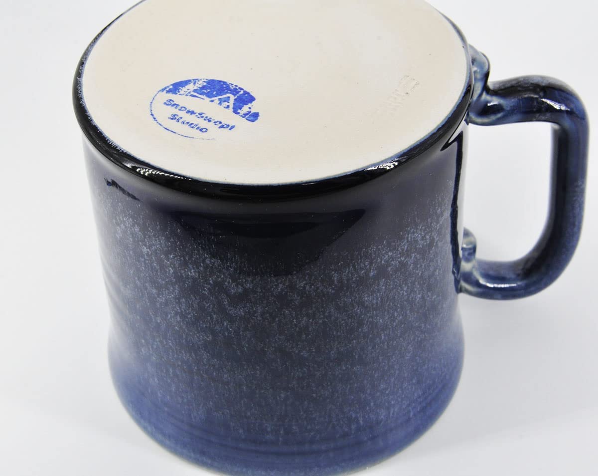 SnowSwept Studio Ol' Blue mug on table evokes warm coffee moments.